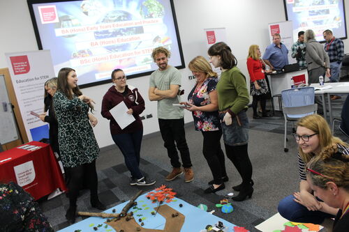 Students and staff taking part in an Education activity at a schools and colleges event at Newport City Campus.