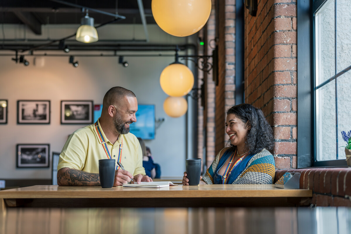 DO NOT USE A man and a woman having a conversation over coffee at Ty Crawshay's cafe