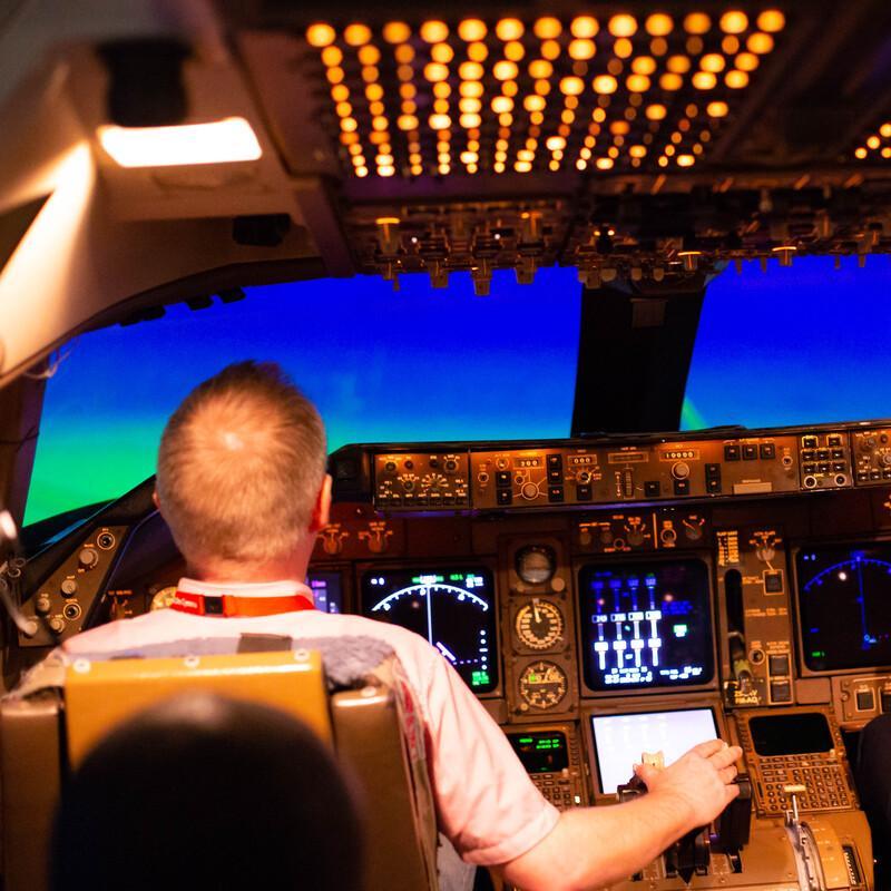 An academic demonstrates how to use the Flight Simulator to a student at the Treforest campus