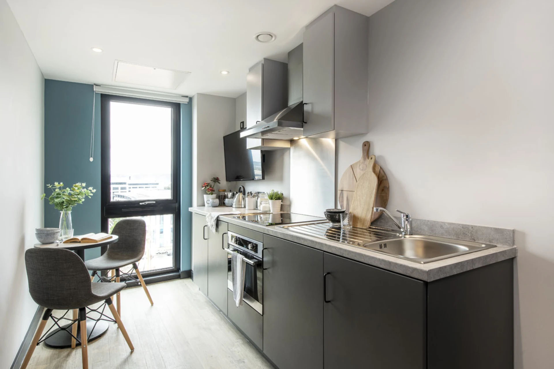 A bright kitchen featuring a sink, microwave, and a dining table