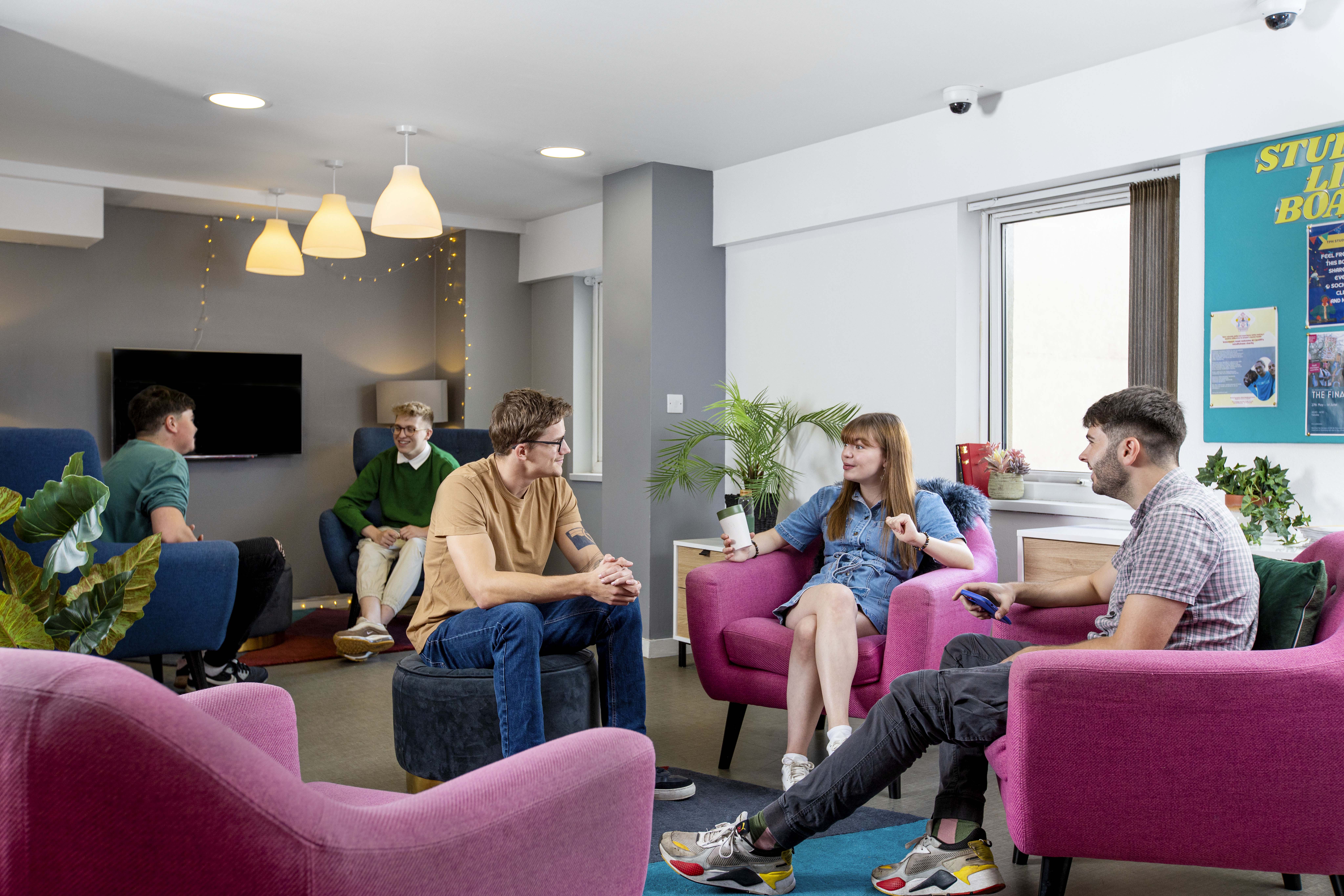 A group of students socialising in the common area of student accommodation in Cardiff