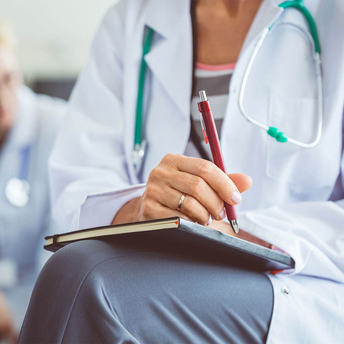 Student nurse taking notes during a lecture