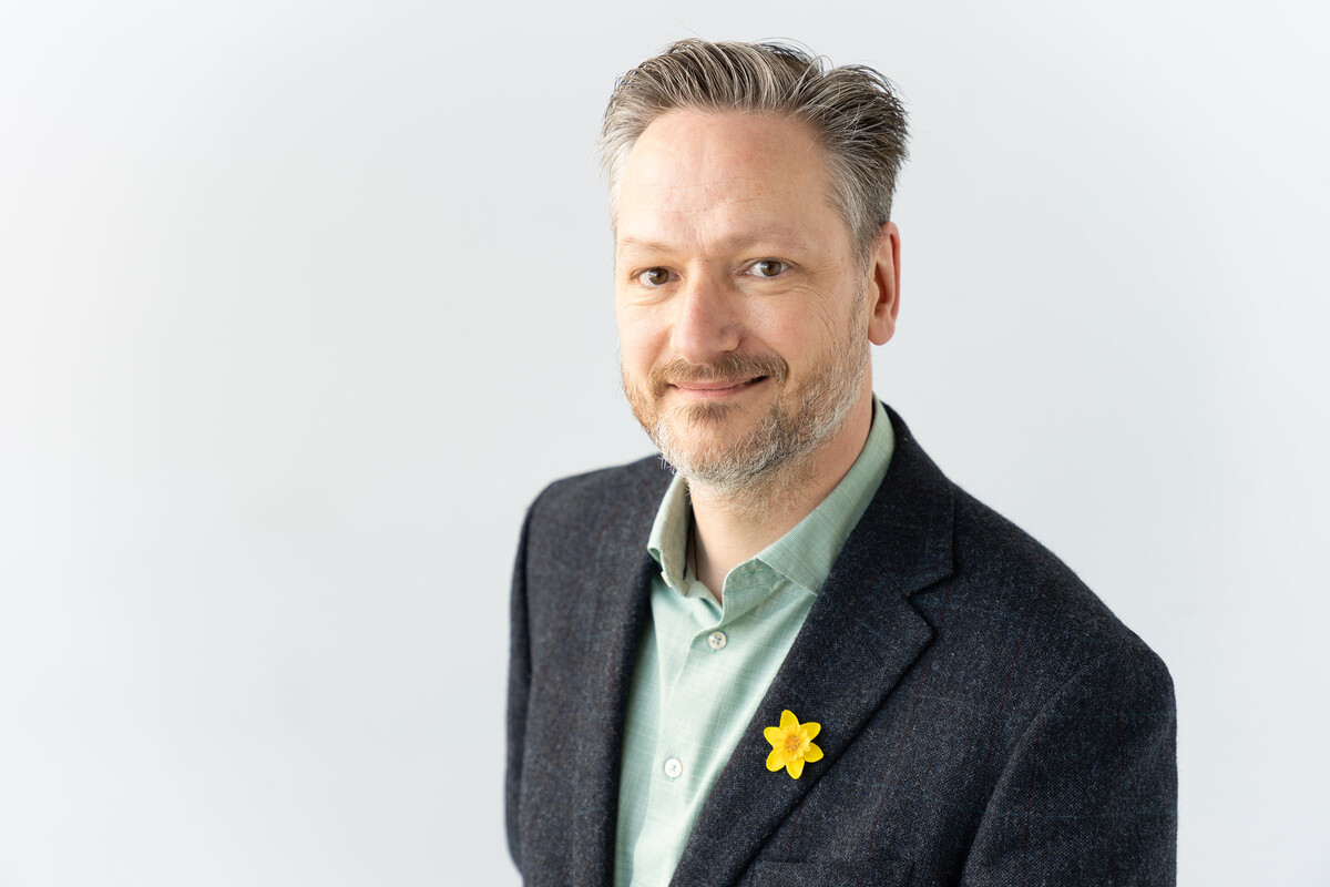 A professional photograph of Professor Gareth Roderique Davies wearing a suit and smiling at the camera.