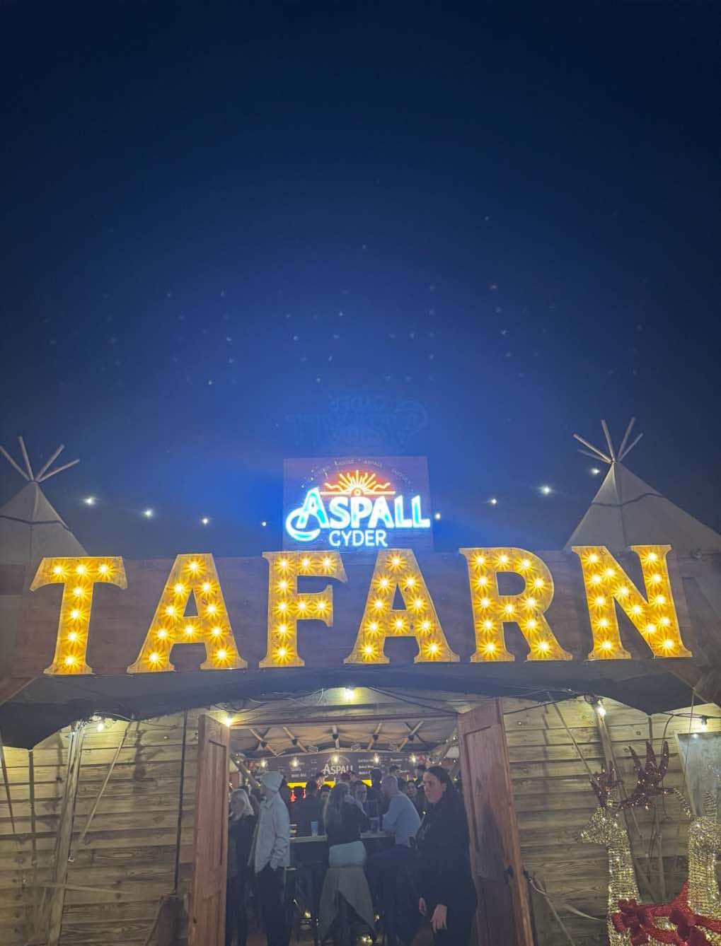 A close up of a sign for the pub at Winter Wonderland which reads, in Welsh, 