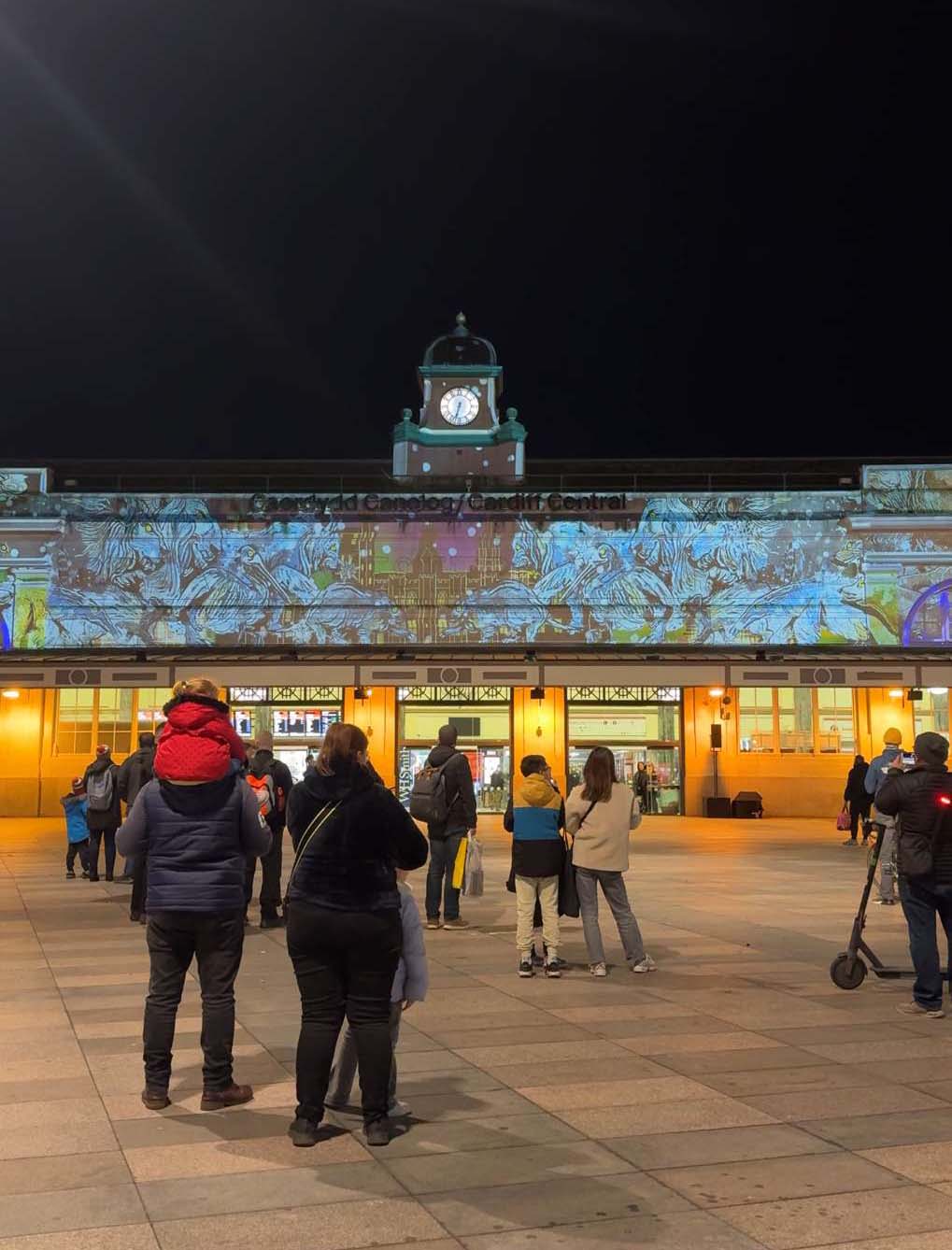 A light show projecting onto the train station at Cardiff Central.
