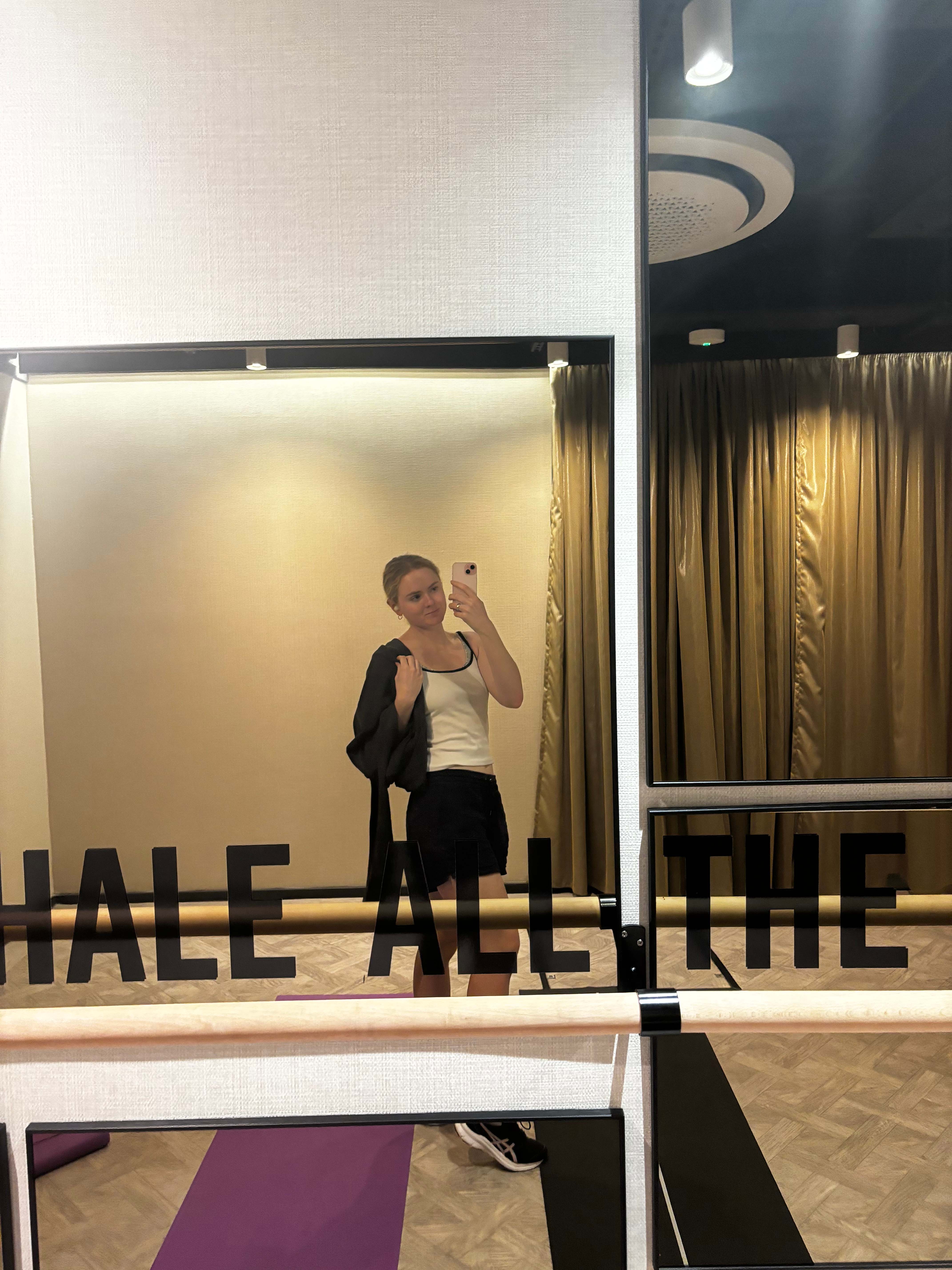 Student, Jade, is taking a selfie in a gym mirror.