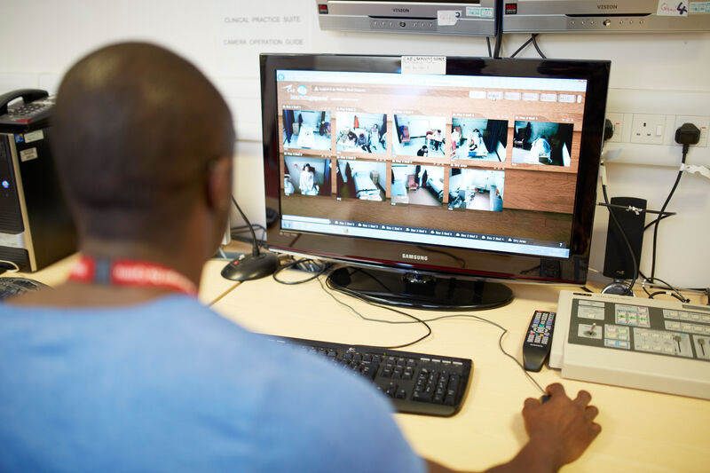 A student nurse looking at images on a computer.
