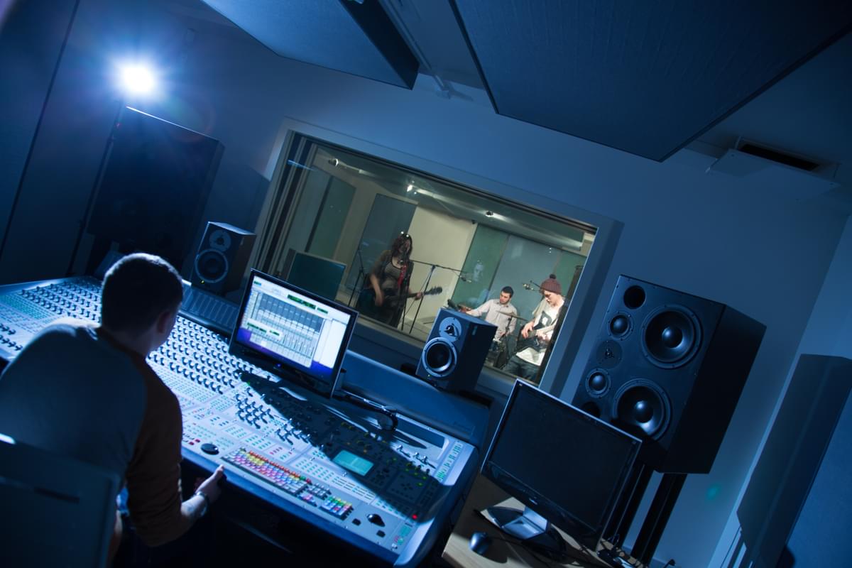 music producing students working at a mixer desk on campus