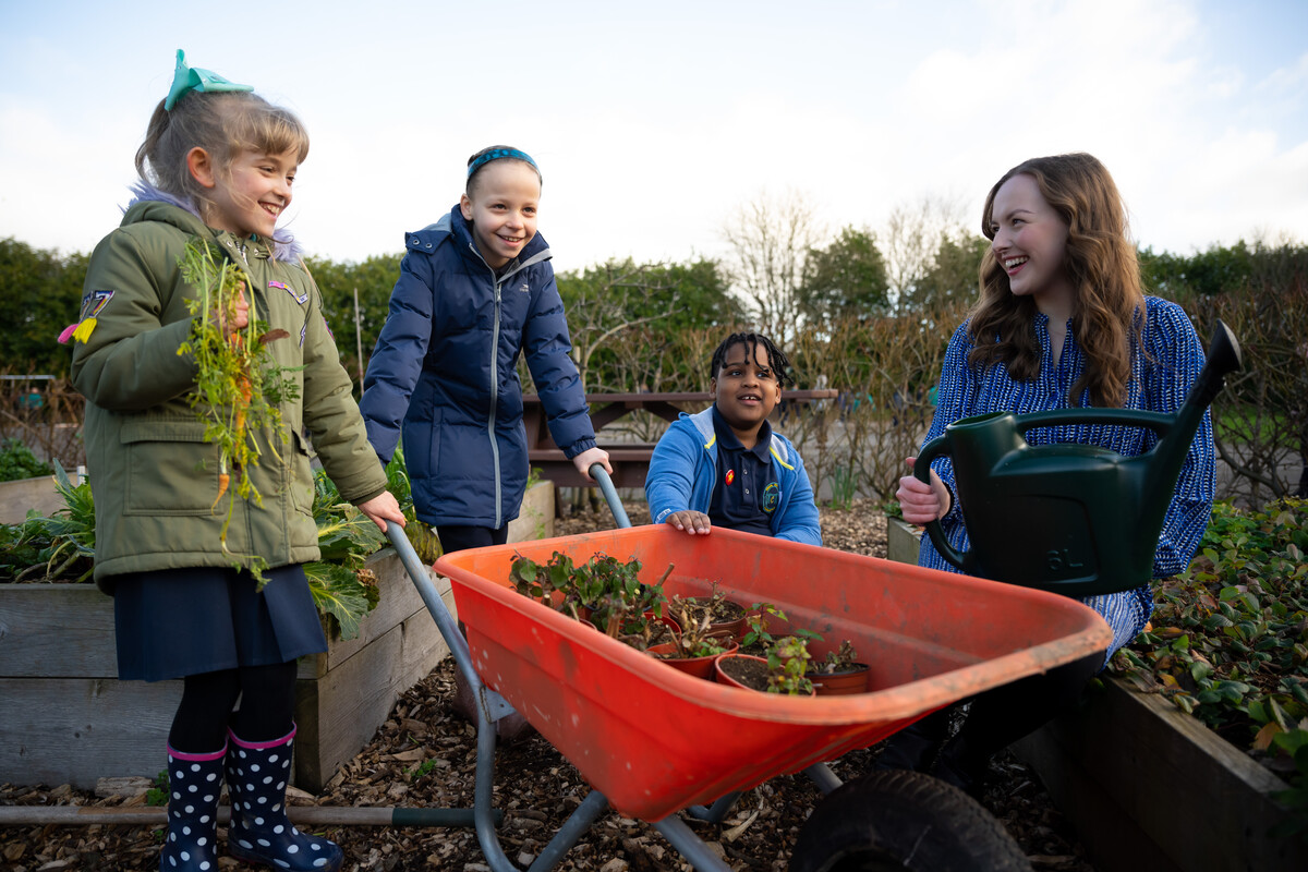 Teaching student doing a practical session with pupils outdoors