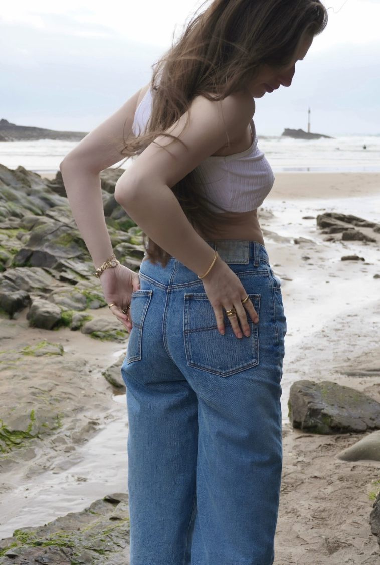 Close up of model wearing denim jeans and a vest top