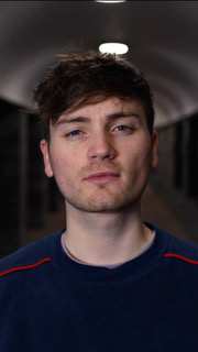 A close-up of student Dan McCadden looking serious at the camera