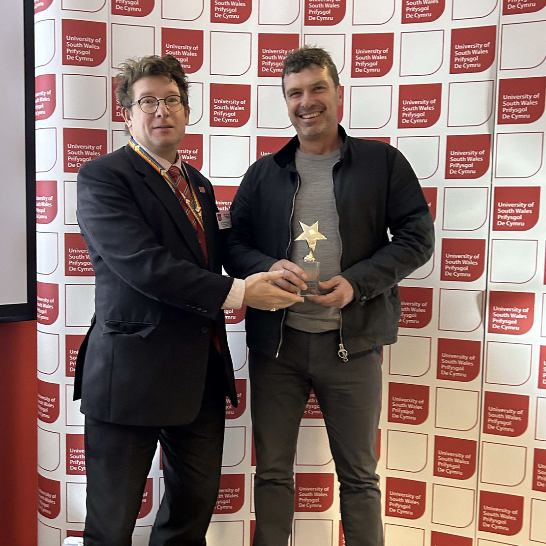 Mike Chick, TESOL lecturer, collects the Social Value award on behalf of E-Cycle