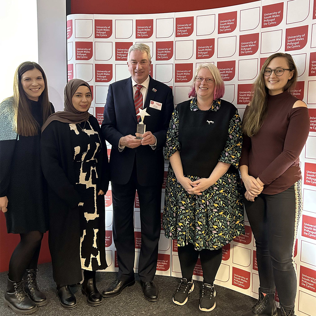 USW Mental Health University Liaison Service team members receiving their award from Dr Ben Calvert, Vice-Chancellor of USW