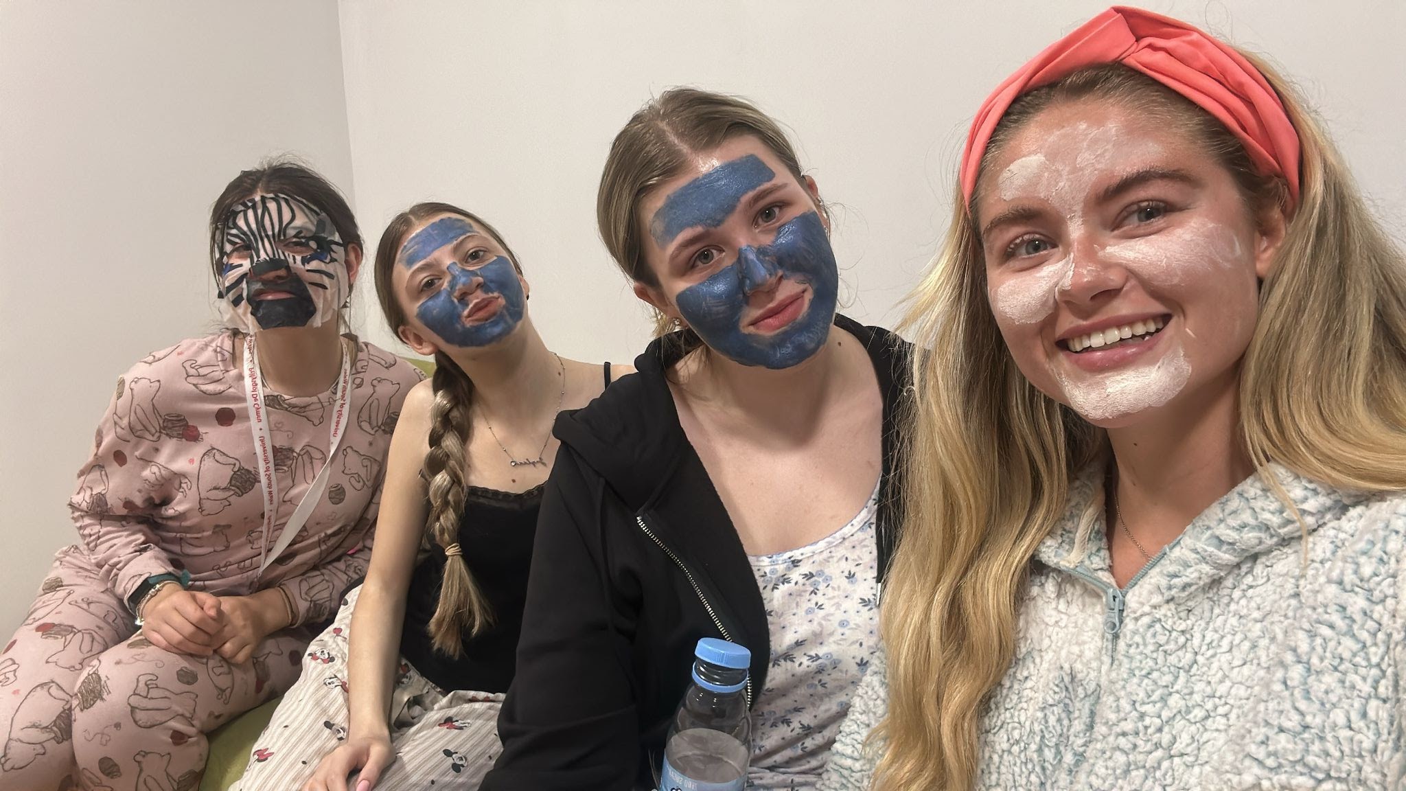 four women wearing face masks