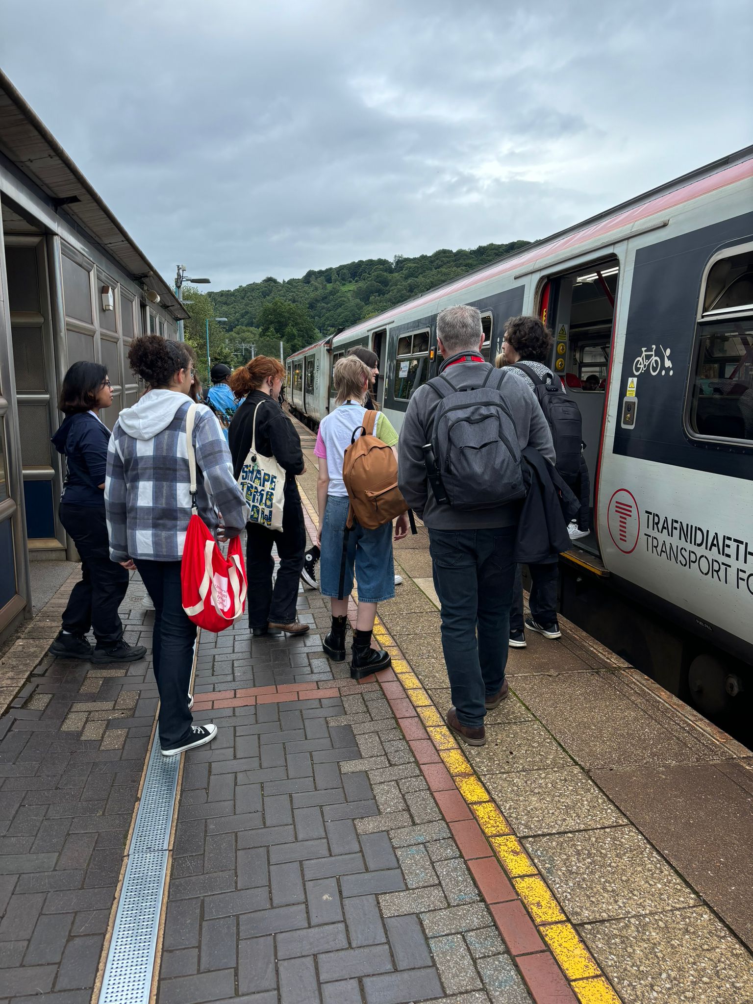 a group of people boarding a train