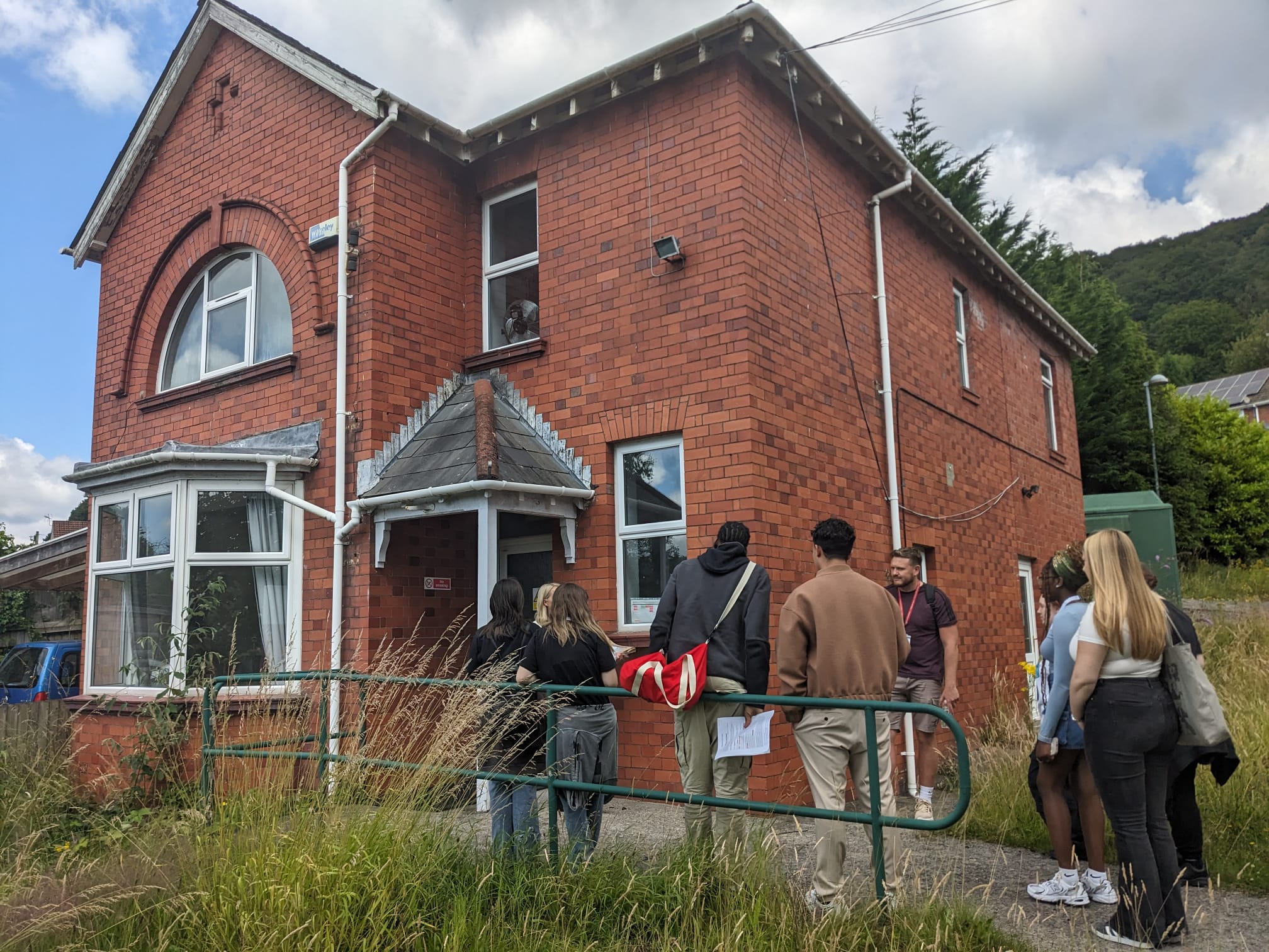 a group of people entering a house