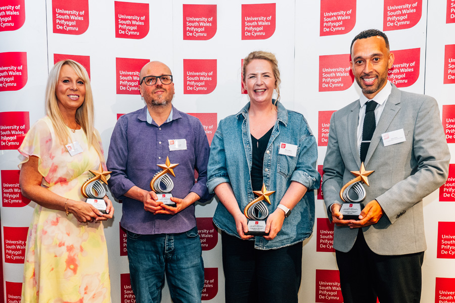Teachers' and Advisers' Awards winners holding their trophies.
