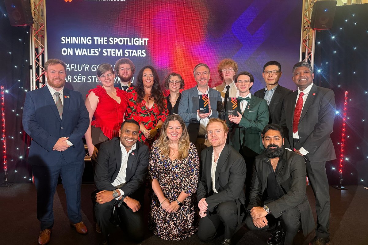 USW staff and students celebrate success at the Wales STEM Awards, posing with award trophies.